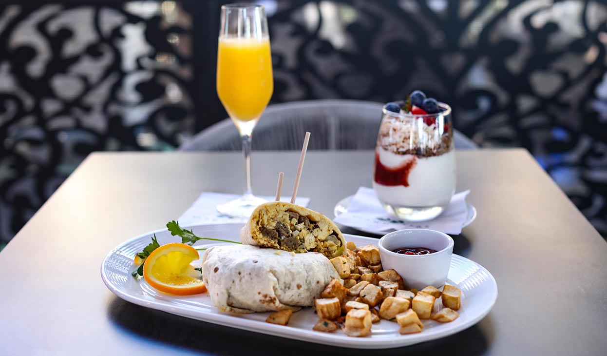 Breakfast burrito with a Paradise Parfait and a Mimosa