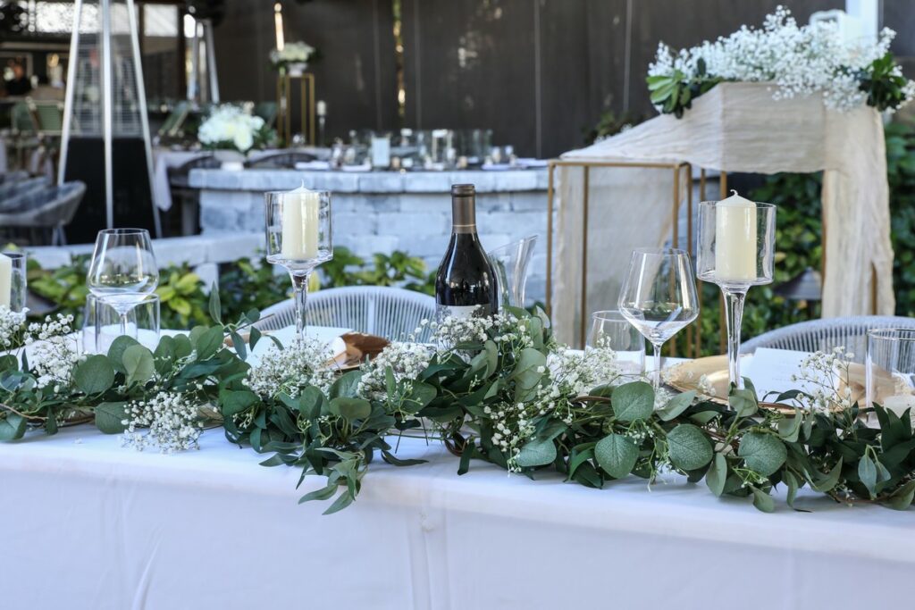 table with a lovely garland of white baby's breath flowers and green leaves